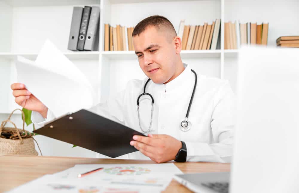 Médecin conseil de la Sécurité Sociale examinant un dossier médical pour fixer un taux d'IPP.