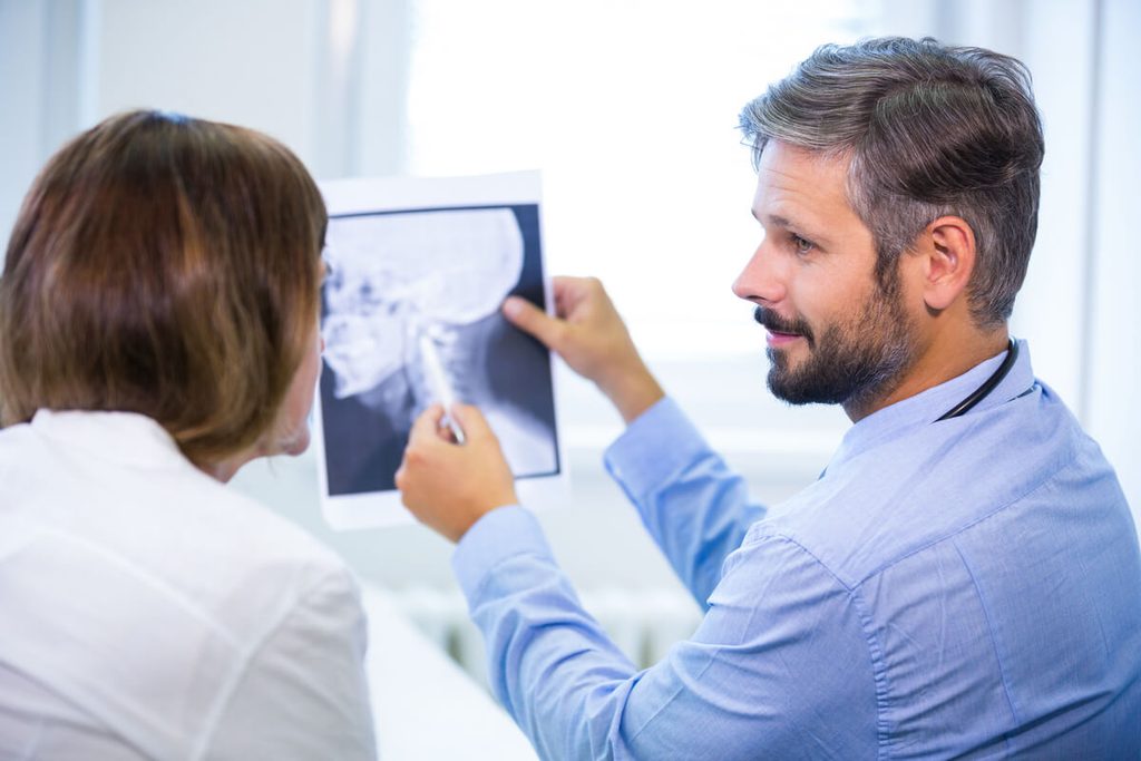 Trame osseuse homogène : signification, radiographie et santé des os 4 Médecin analysant un compte-rendu radiologique décrivant une trame osseuse homogène.