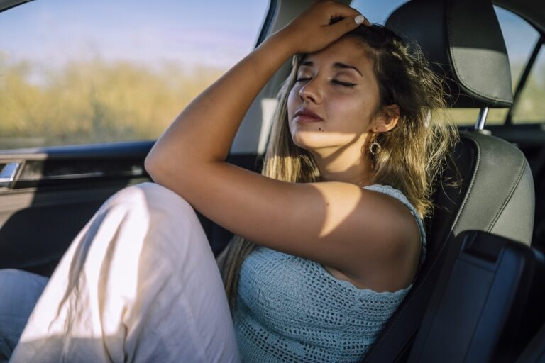 Accueil 1 Femme assise confortablement sur le siège passager d'une voiture après son transfert embryonnaire.